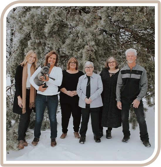 A group of people standing in front of a tree.