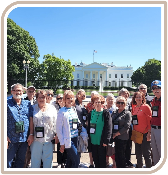 A group of people standing in front of the white house.