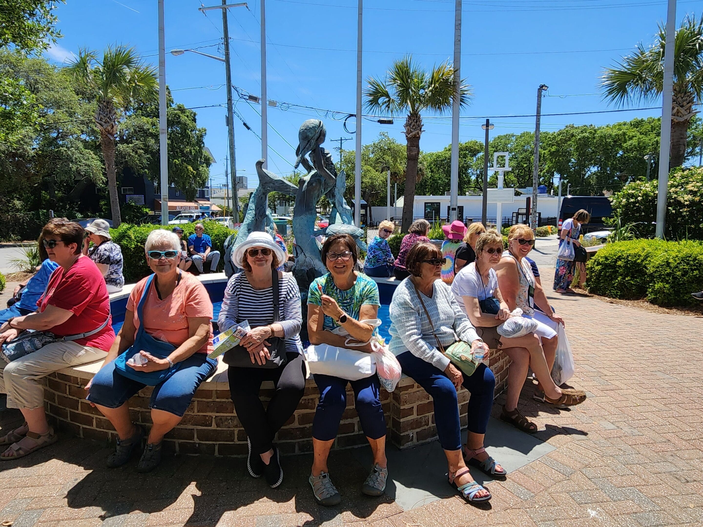 A group of people sitting on top of a bench.