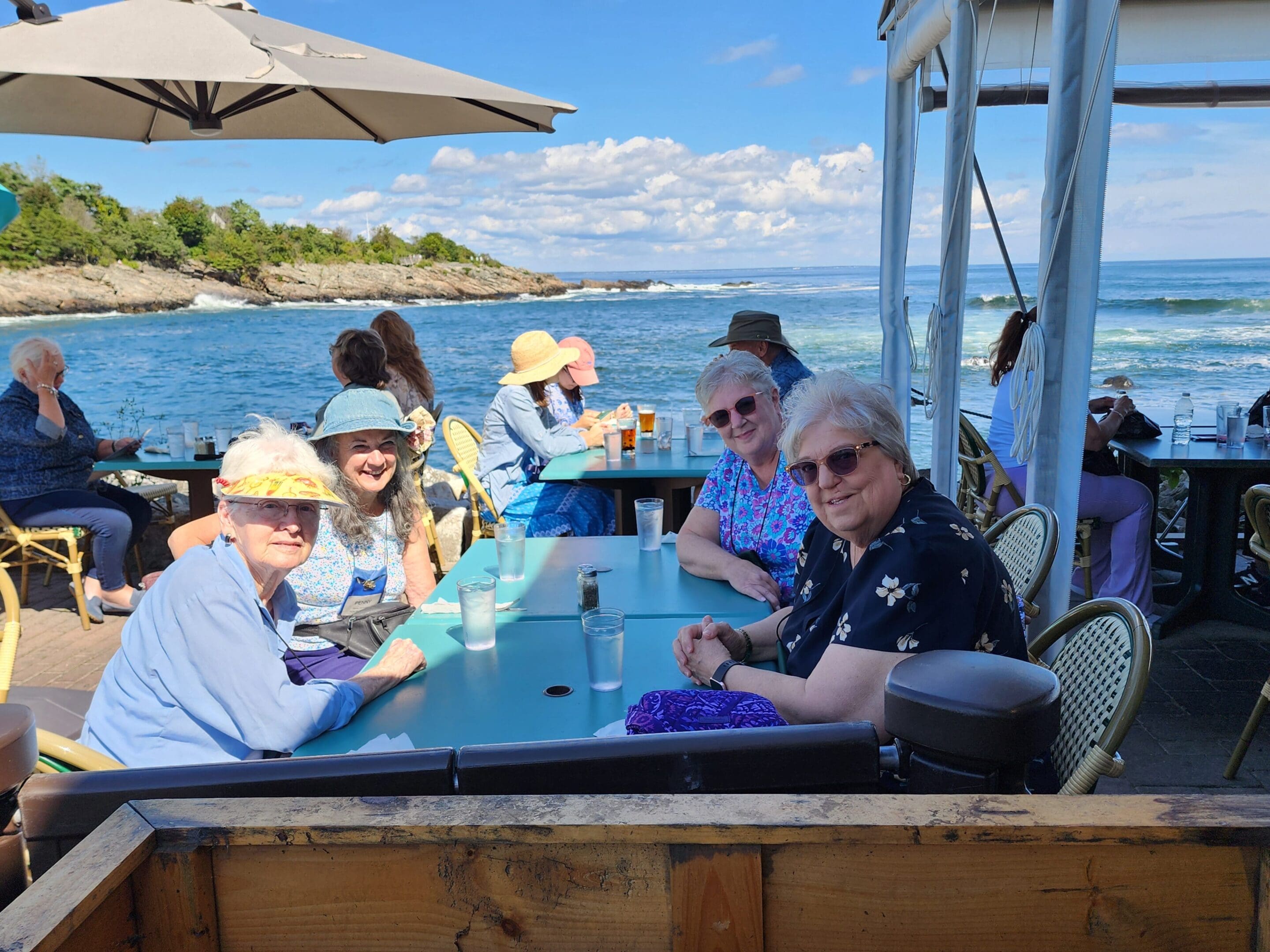 A group of people sitting at the table on a boat.