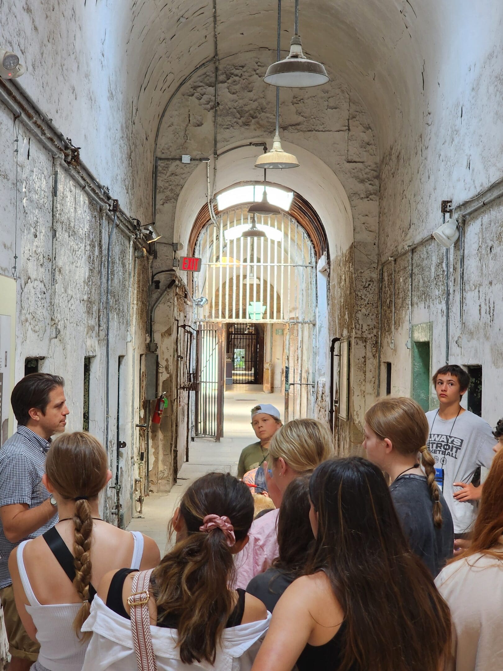 A group of people standing in an old building.