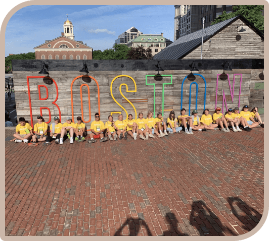 A group of people sitting on top of a brick road.