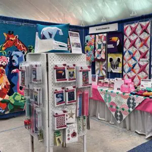 A room with many different types of quilts on display.