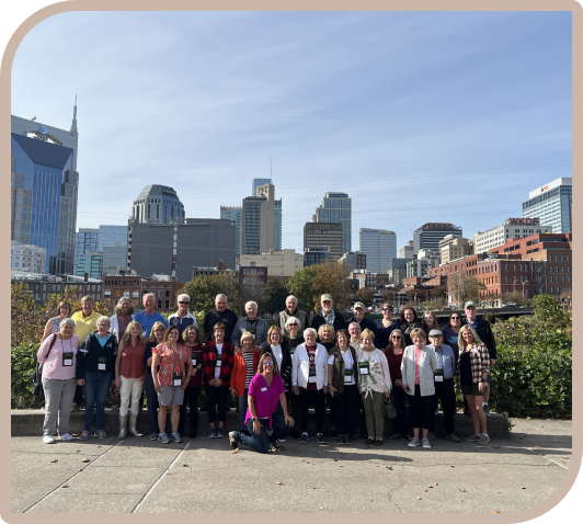 A group of people standing in front of some buildings