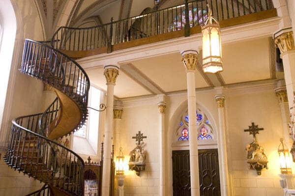 Ornate spiral staircase in a chapel.