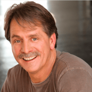 Headshot of a smiling man with a mustache.